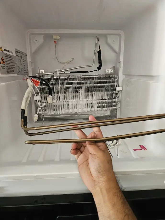 Defrost heater replacement inside refrigerator evaporator compartment