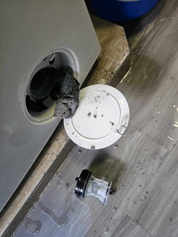 Blocked washing machine drain filter causing drainage problems